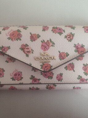 Brand new Coach floral slim wallet. Never used.